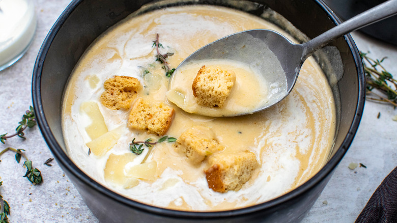 creamy roasted garlic soup with spoon