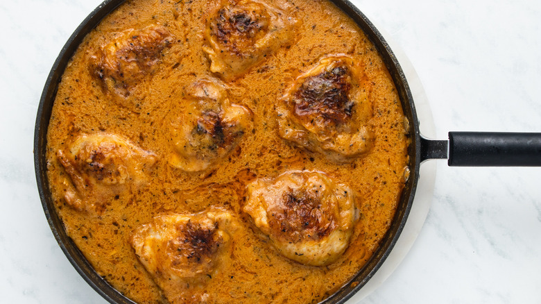 chicken thighs and sauce in pan