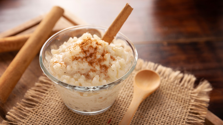 eggnog rice pudding in a glass with cinnamon sticks