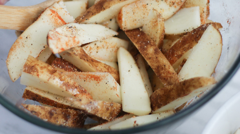 Wooden spoon stirring seasoning