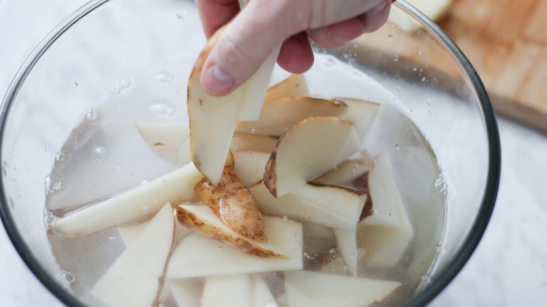 Potato wedges soaking in cold water