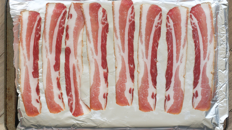 raw bacon on baking tray