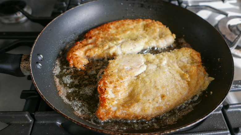 breaded chicken pieces frying