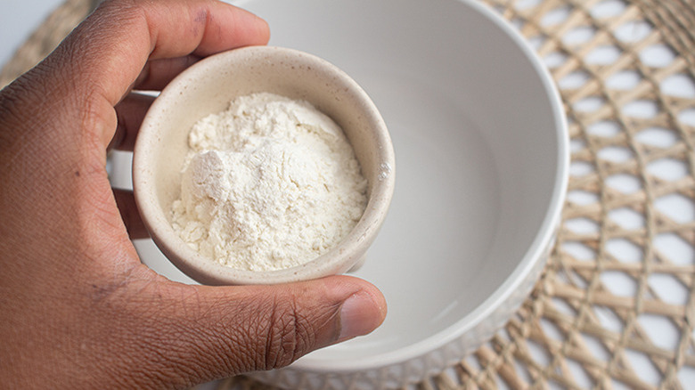 woman's hand holding flour