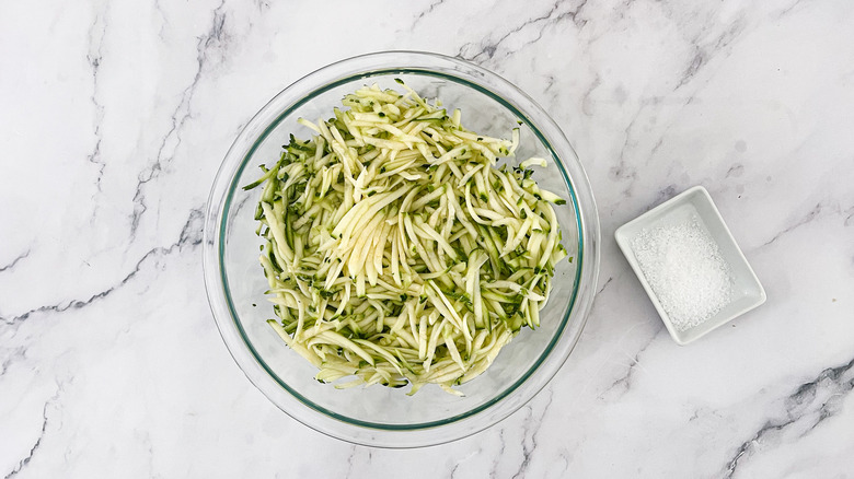 Grated zucchini and salt