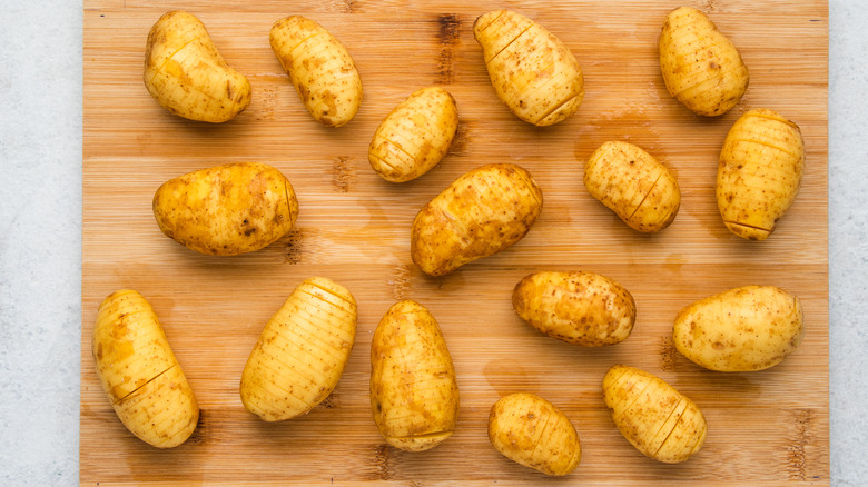 hasselback potatoes on a cutting board 