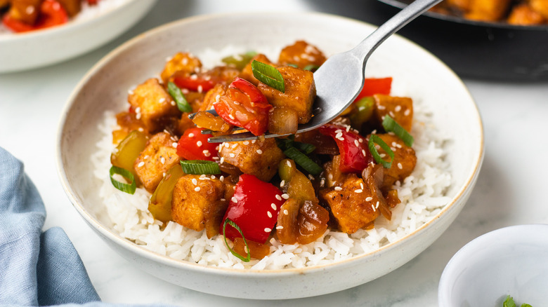 Fork taking bite of tofu