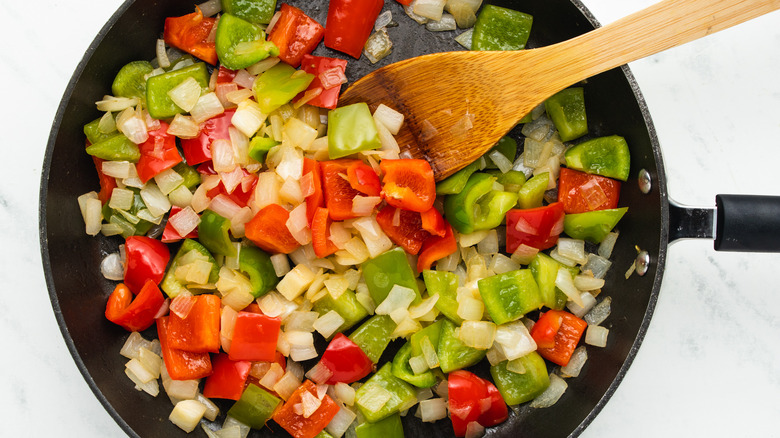 Onion and peppers frying in pan