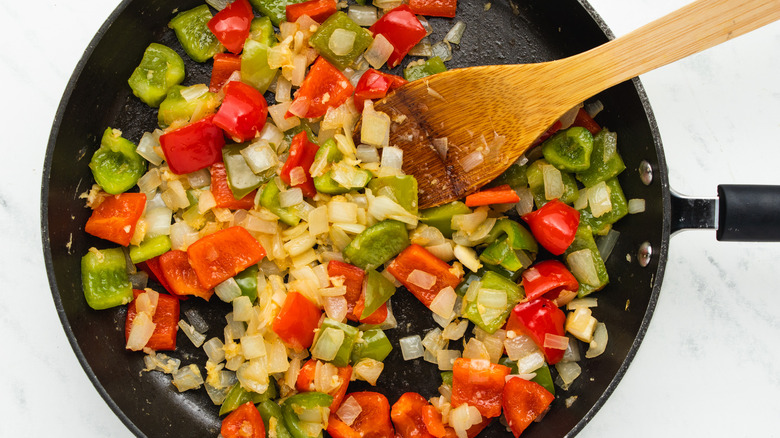 Onion and peppers frying in pan