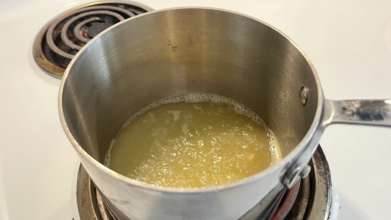 yellow liquid in metal pot