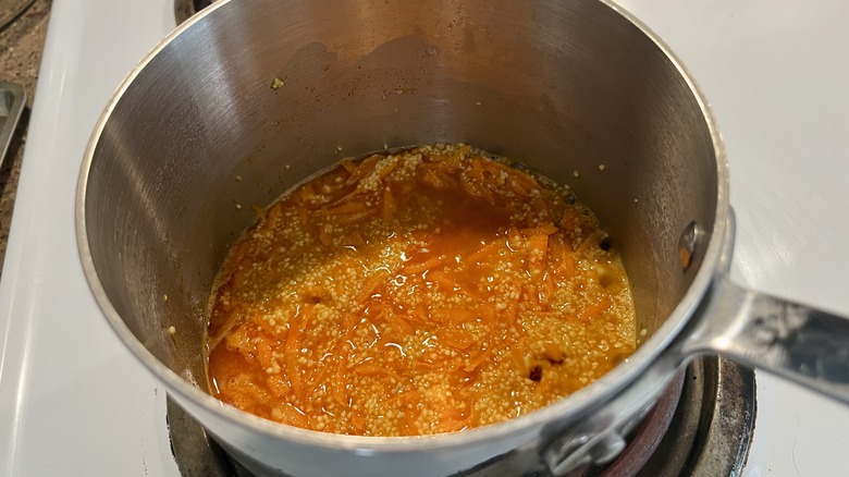 couscous and carrots in pot