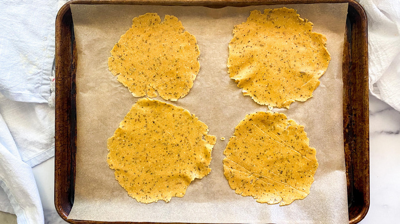 Papadum dough on a baking tray