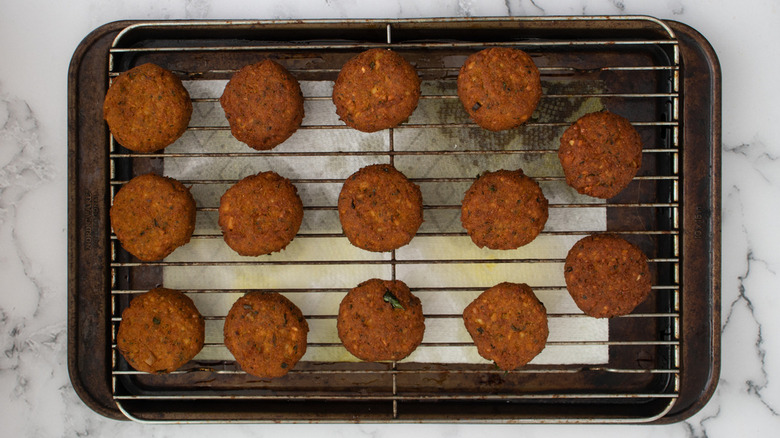 cooked falafel patties on rack