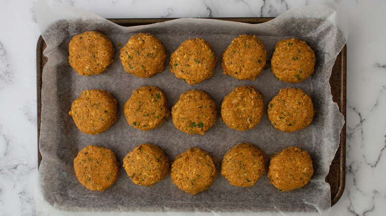 uncooked falafel patties on tray