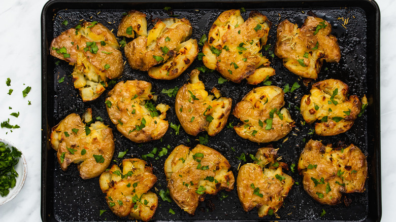 smashed potatoes on a pan 