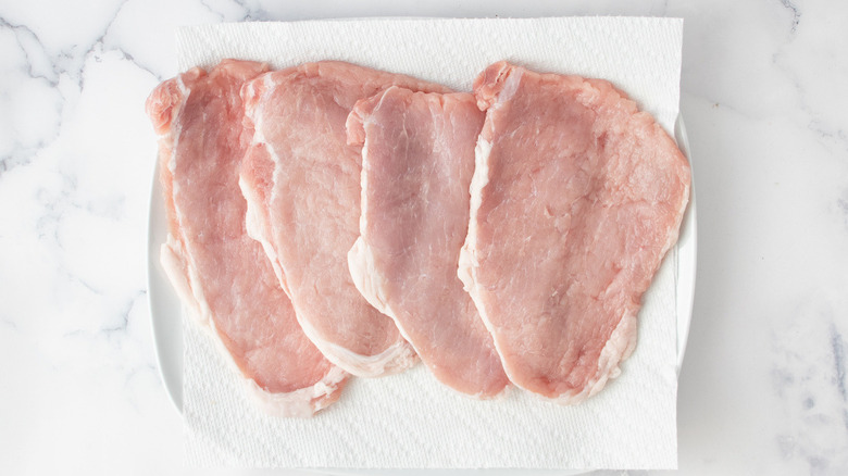 raw veal cutlets on a paper towel