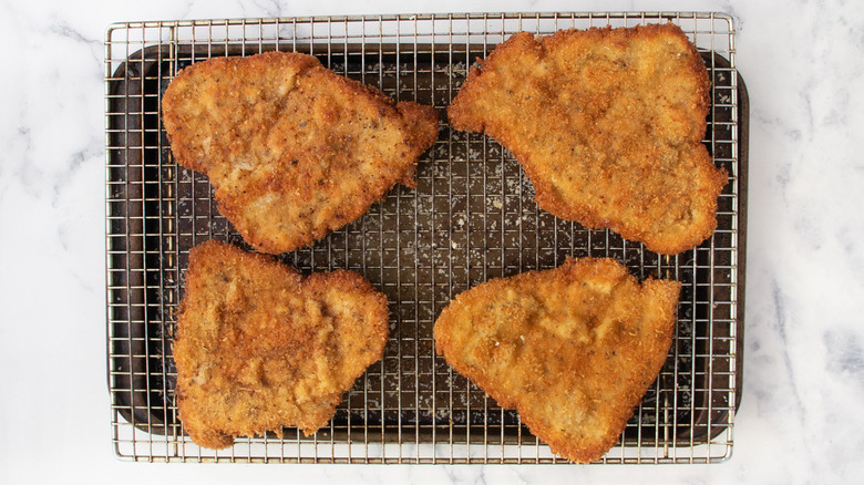 fried breaded cutlets on a wire rack