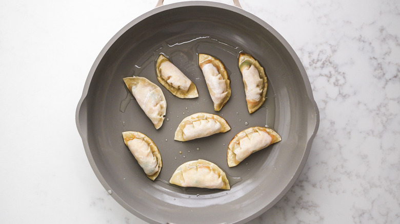 potstickers cooking in pan