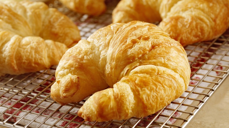 curved croissants on cooling rack