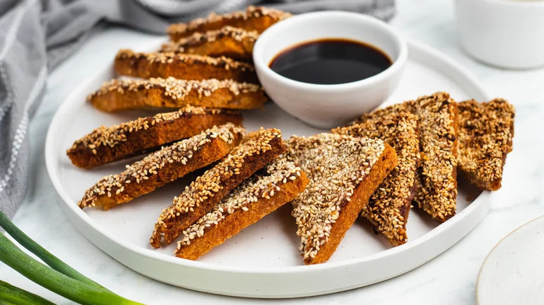 plate of shrimp toast and dipping sauce