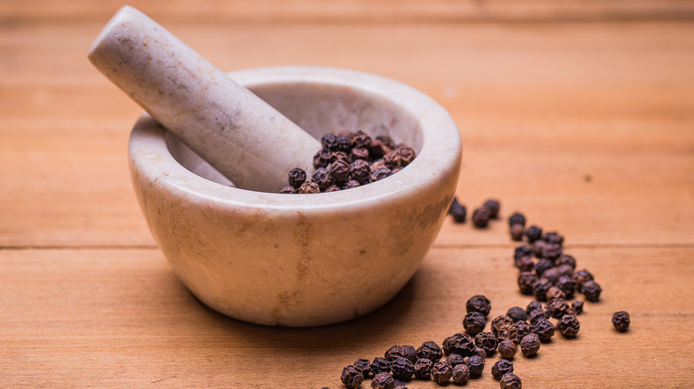 Mortar and pestle with peppercorns