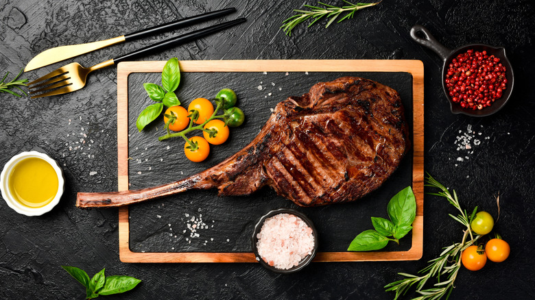 grilled tomahawk steak on cutting board