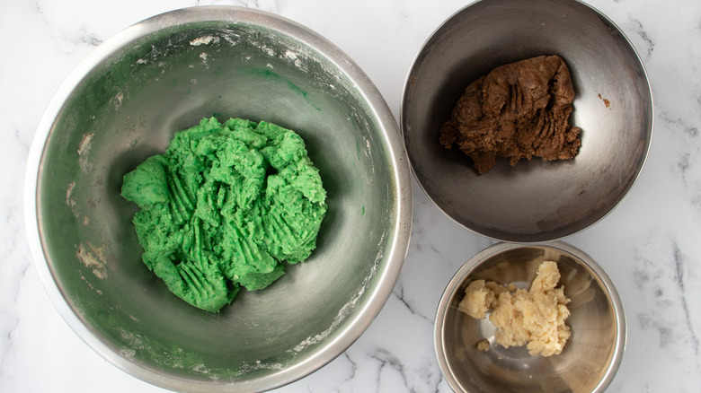 colorful dough in three bowls