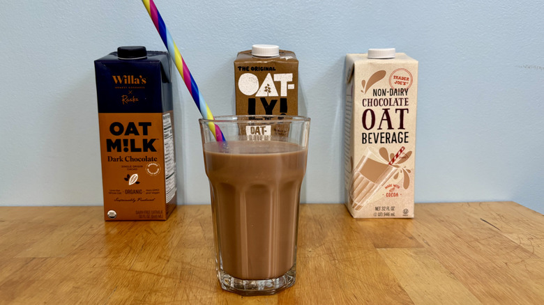 Glass of non-dairy chocolate milk with a colorful straw