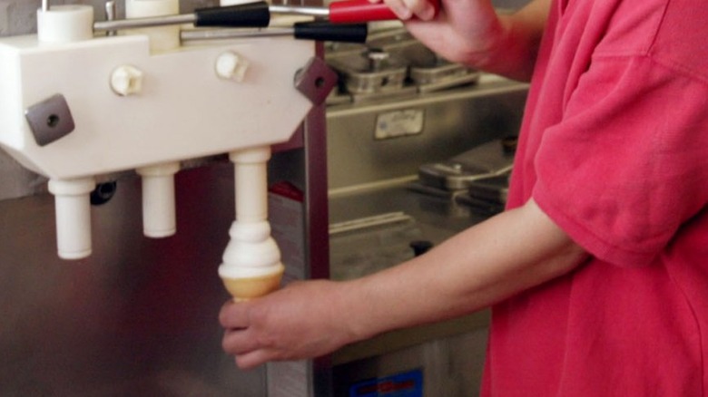 DQ server serving up a soft serve cone