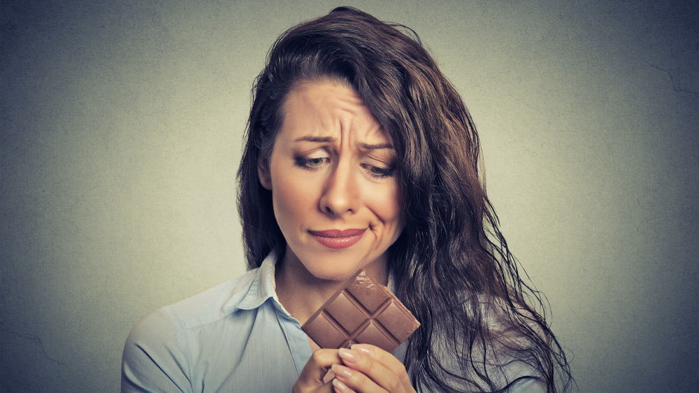 Woman unhappy with chocolate bar