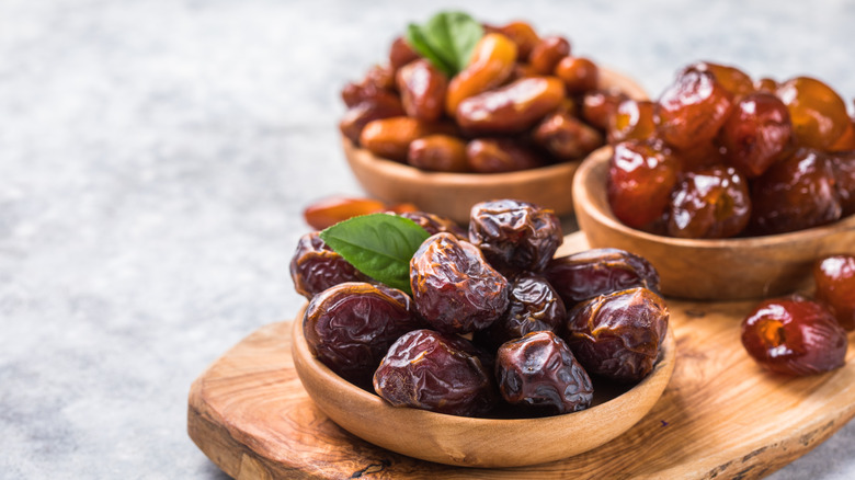 Assortment of dried dates in wooden bowls