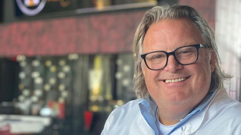 Chef David Burke smiling with glasses