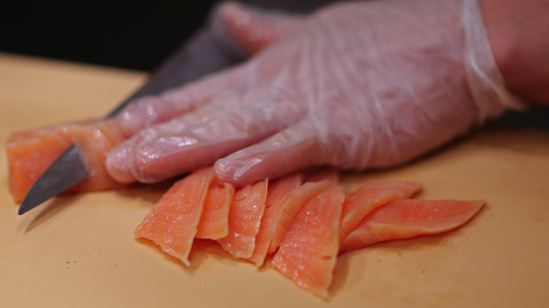 Cutting fish for sushi