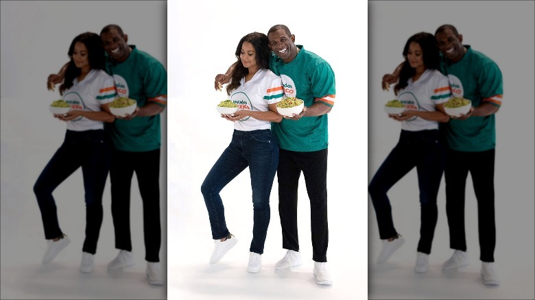 Tracey Edmonds and Deion Sanders holding guacamole