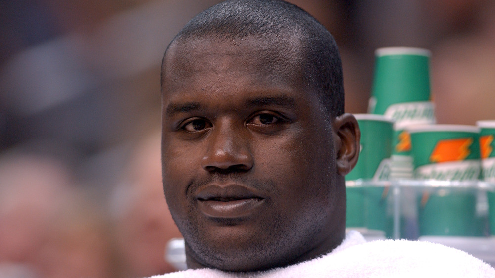 Shaquille O'Neal smirking for the camera on the sidelines