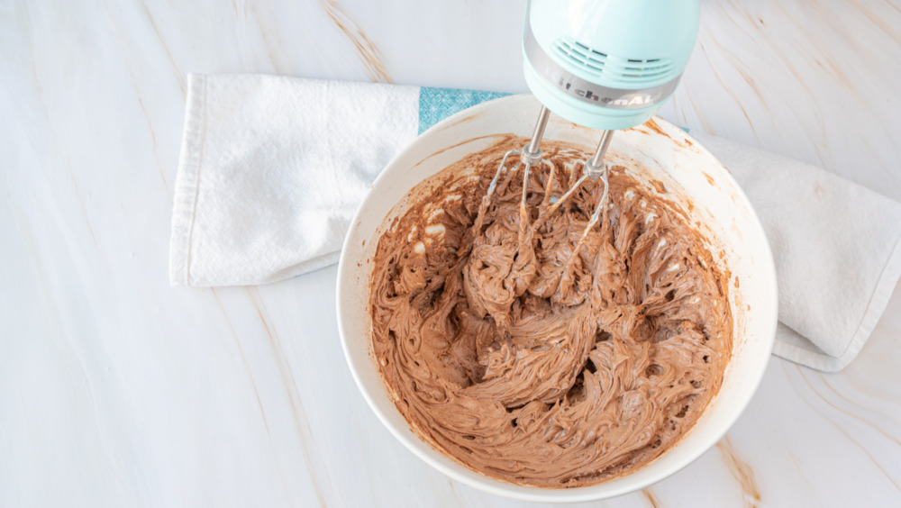 mixing chocolate cupcakes frosting