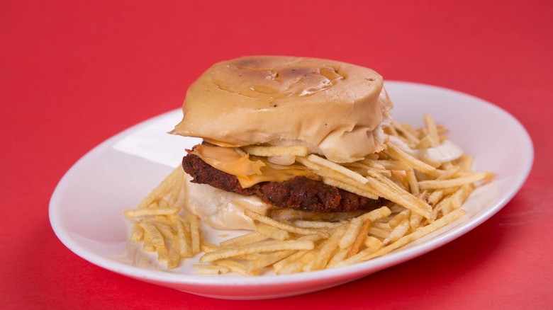 frita cubana with cheese on red background