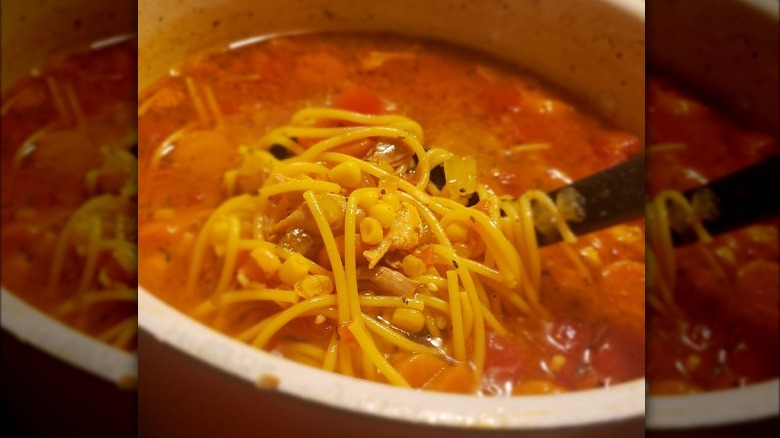 spoon lifting sopa de pollo