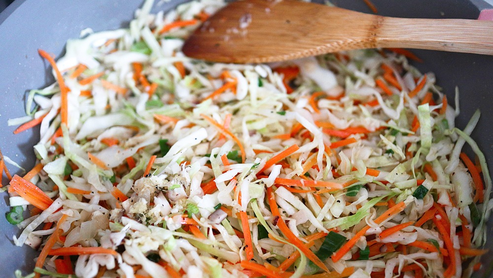 Stir frying veggies in a skillet for egg rolls