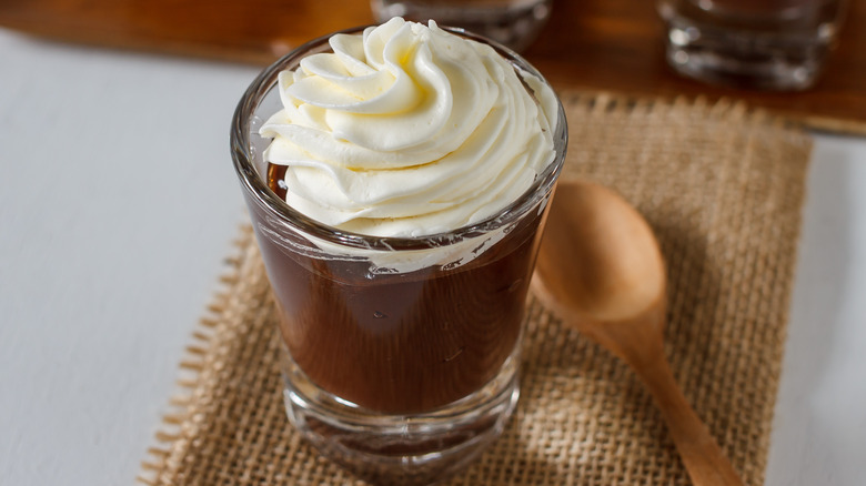 chocolate pudding in shot glass with whipped cream