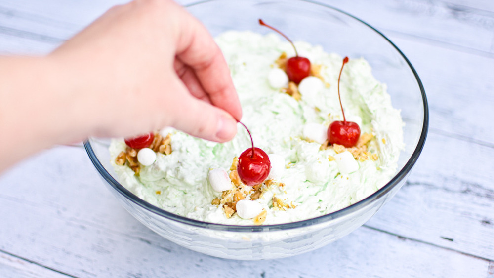 Putting maraschino cherries on Watergate salad