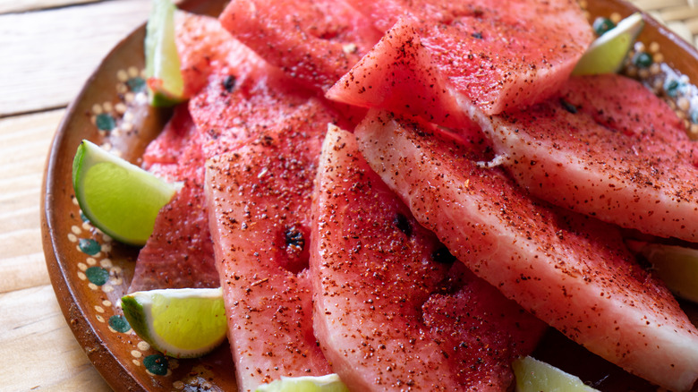 seasoned watermelon slices with lime wedges