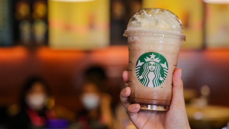 Hand holding frozen Starbucks beverage