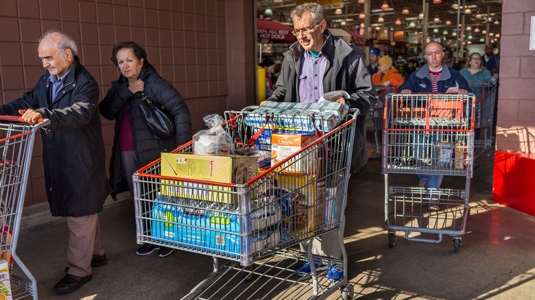 Costco customers pushing shopping carts