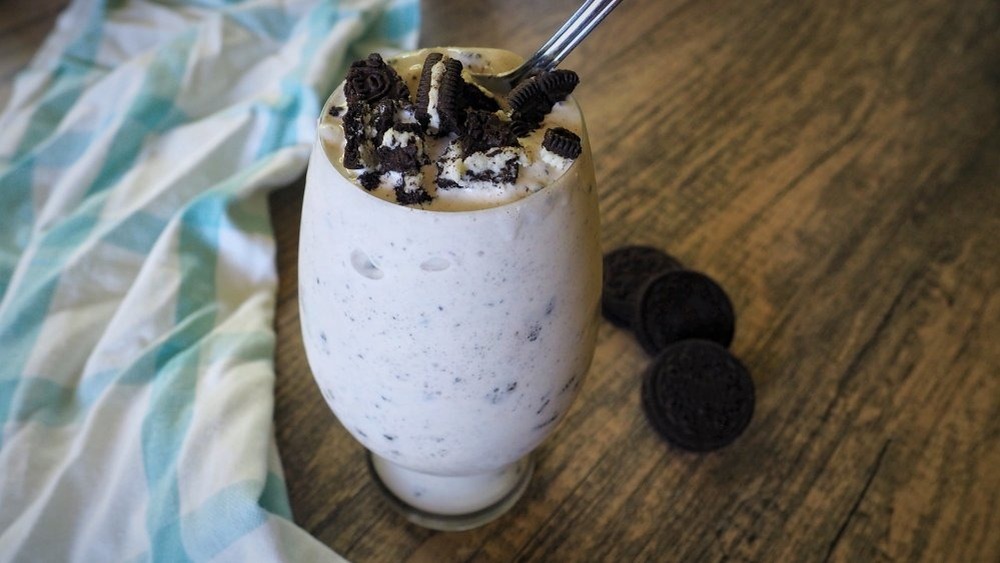 Oreo shake in a glass with spoon