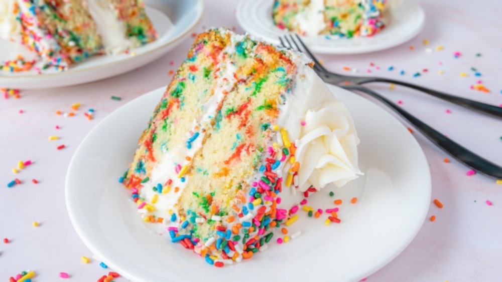 Funfetti cake on white plate with fork