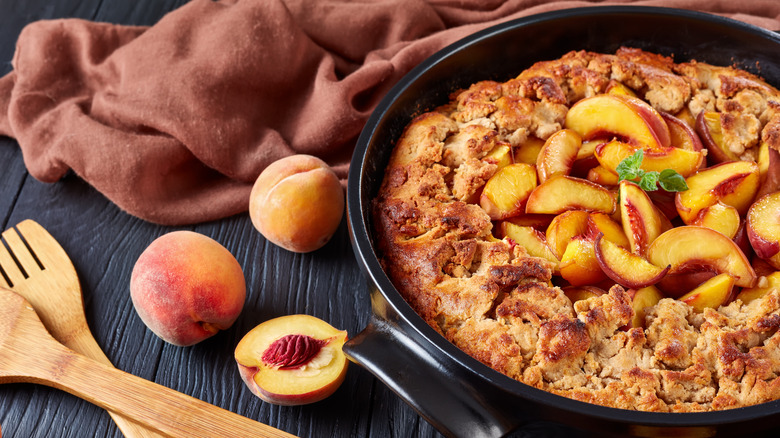 peach cobbler in black dish