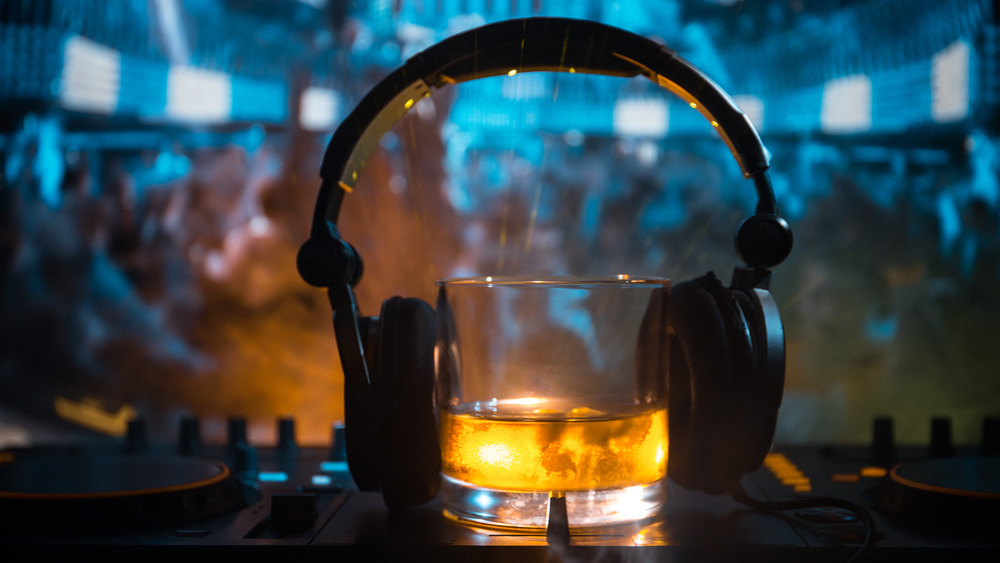 Glass of whiskey with headphones