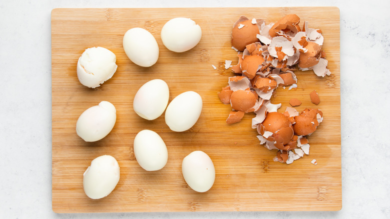 peeled boiled eggs on cutting board