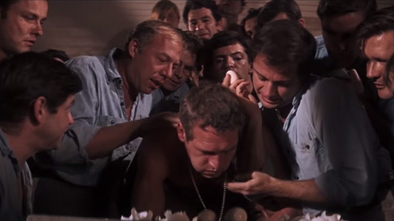 Paul Newman is seen eating eggs with group of men